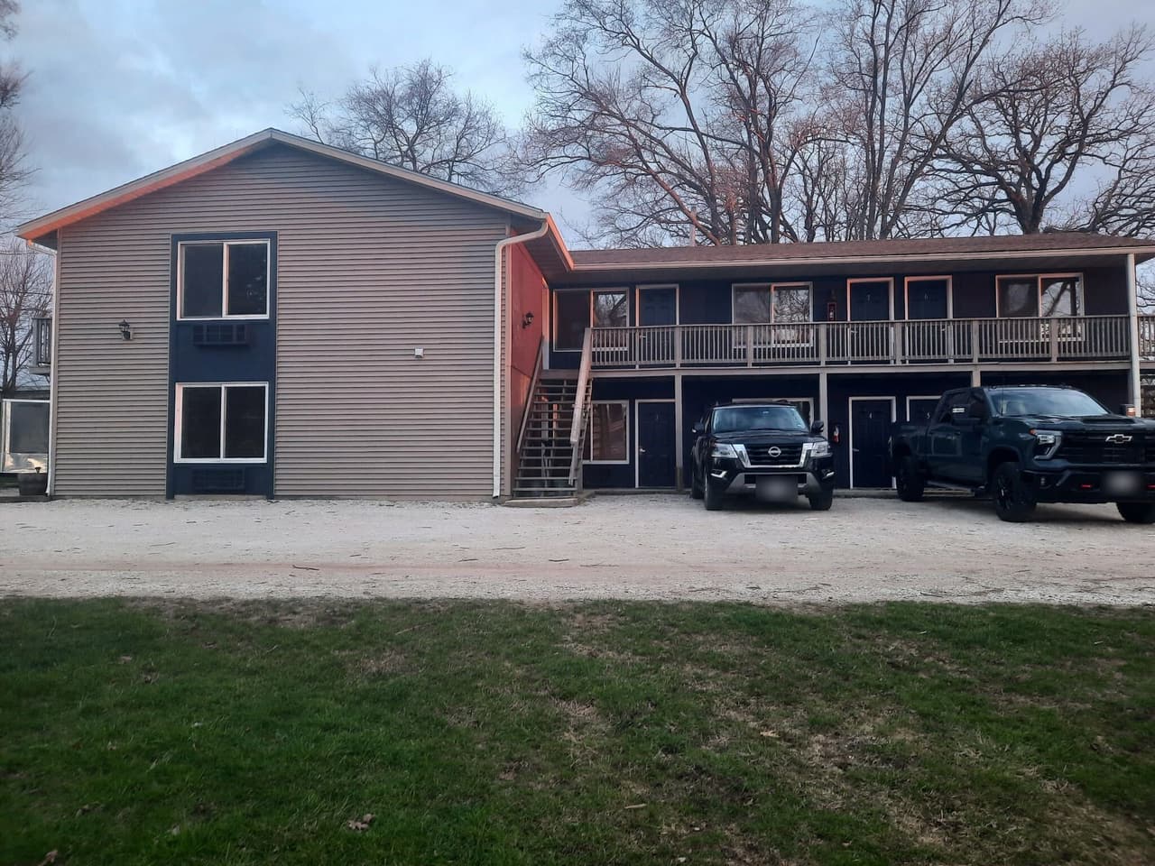 The two-story guest room wing with parking out front