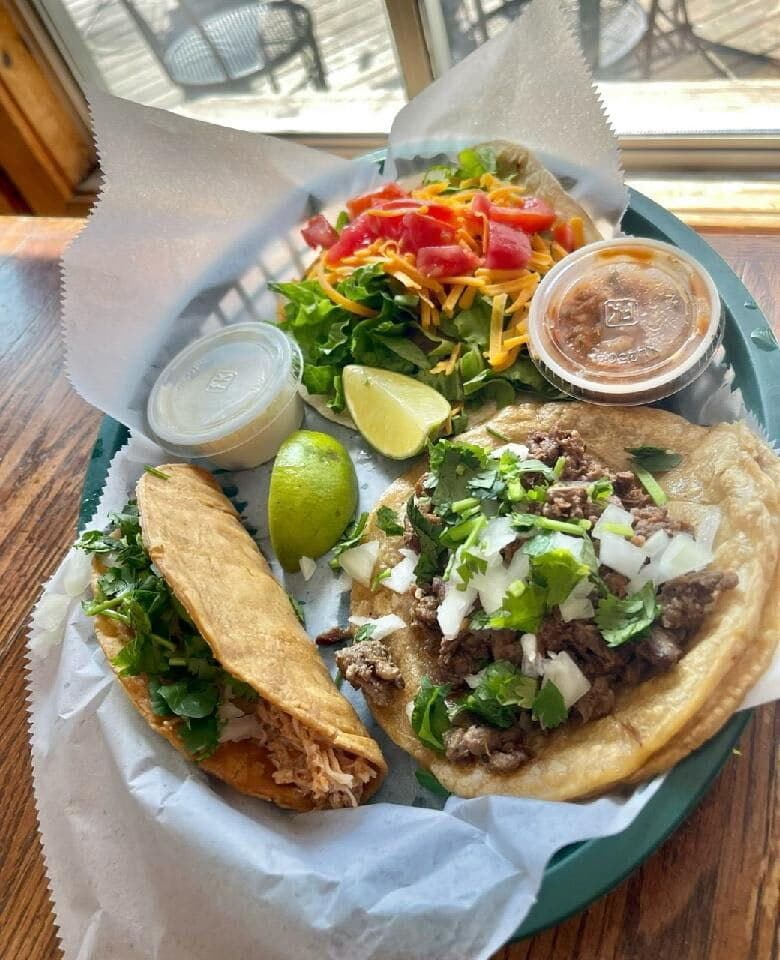 Steak tacos with onion and cilantro, lime, salsa and a crispy hard-shell taco