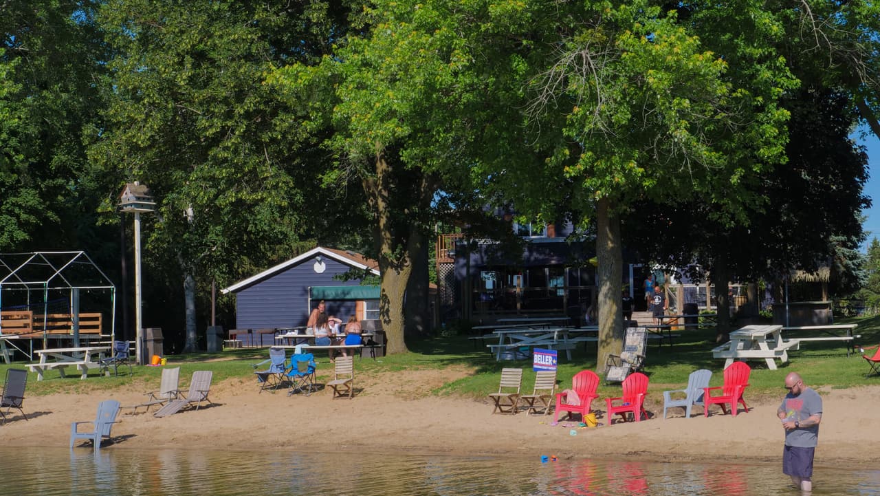 Families on the sandy beach and in the swim area at Lily Lake Resort