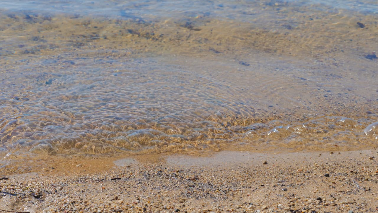 Clear water over the sandy lake bottom at the swim area